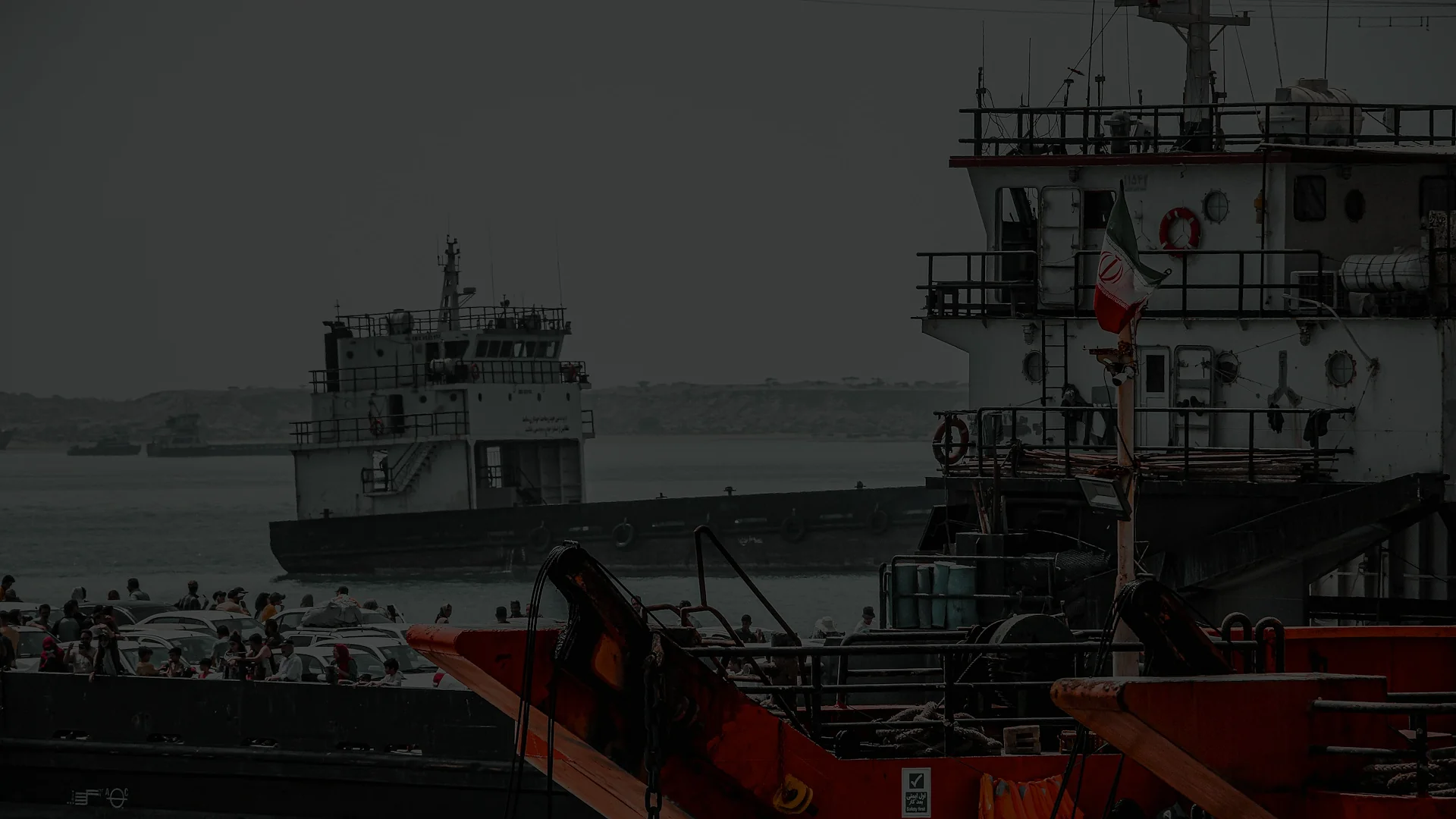 An oil tanker at sea under a hazy sky, representing OFAC sanctions on Iranian petroleum shipping