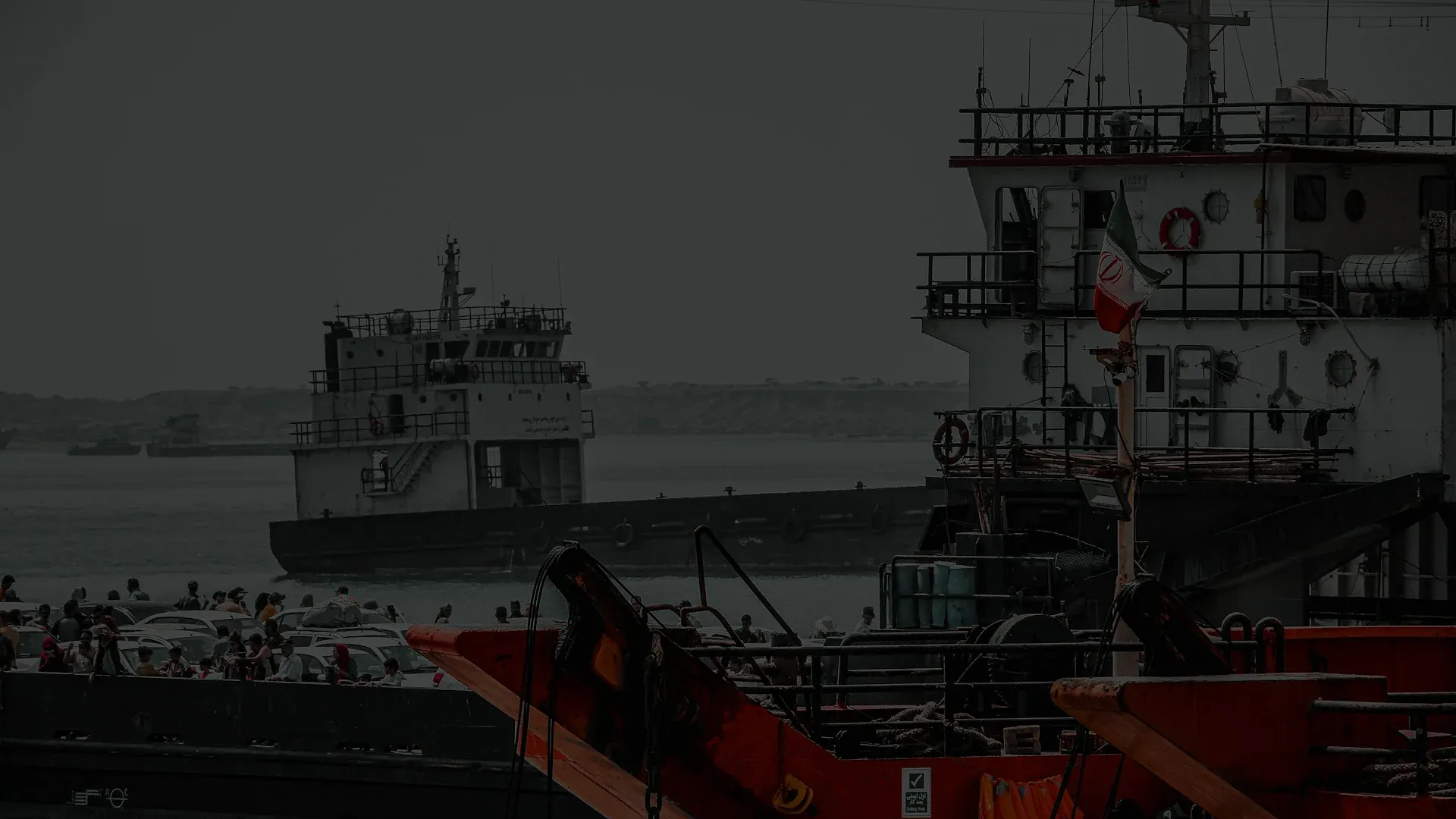 An oil tanker at sea under a hazy sky, representing OFAC sanctions on Iranian petroleum shipping