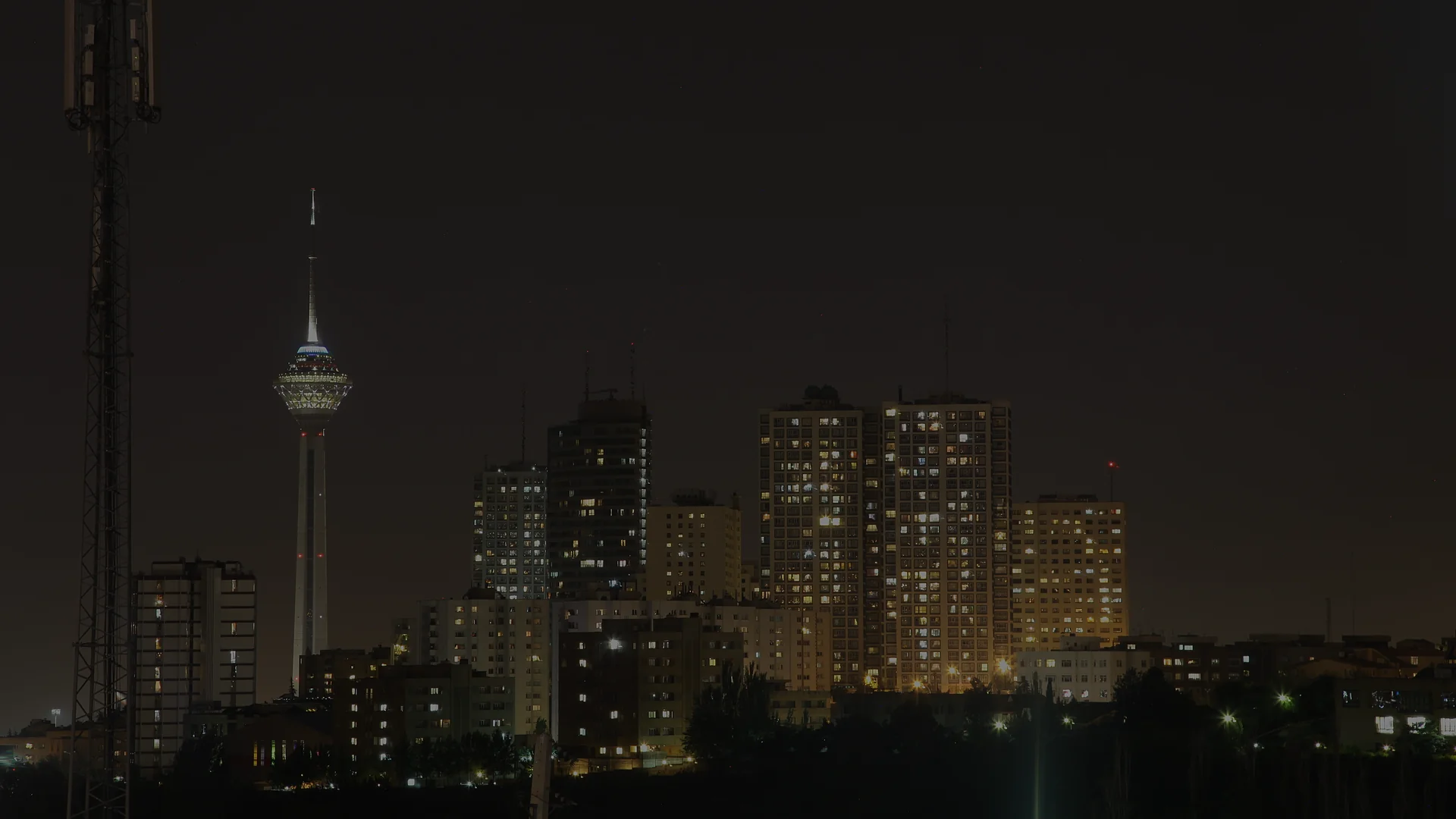 The Tehran skyline at dusk, illustrating the civilian impact of broad U.S. sanctions on Iran