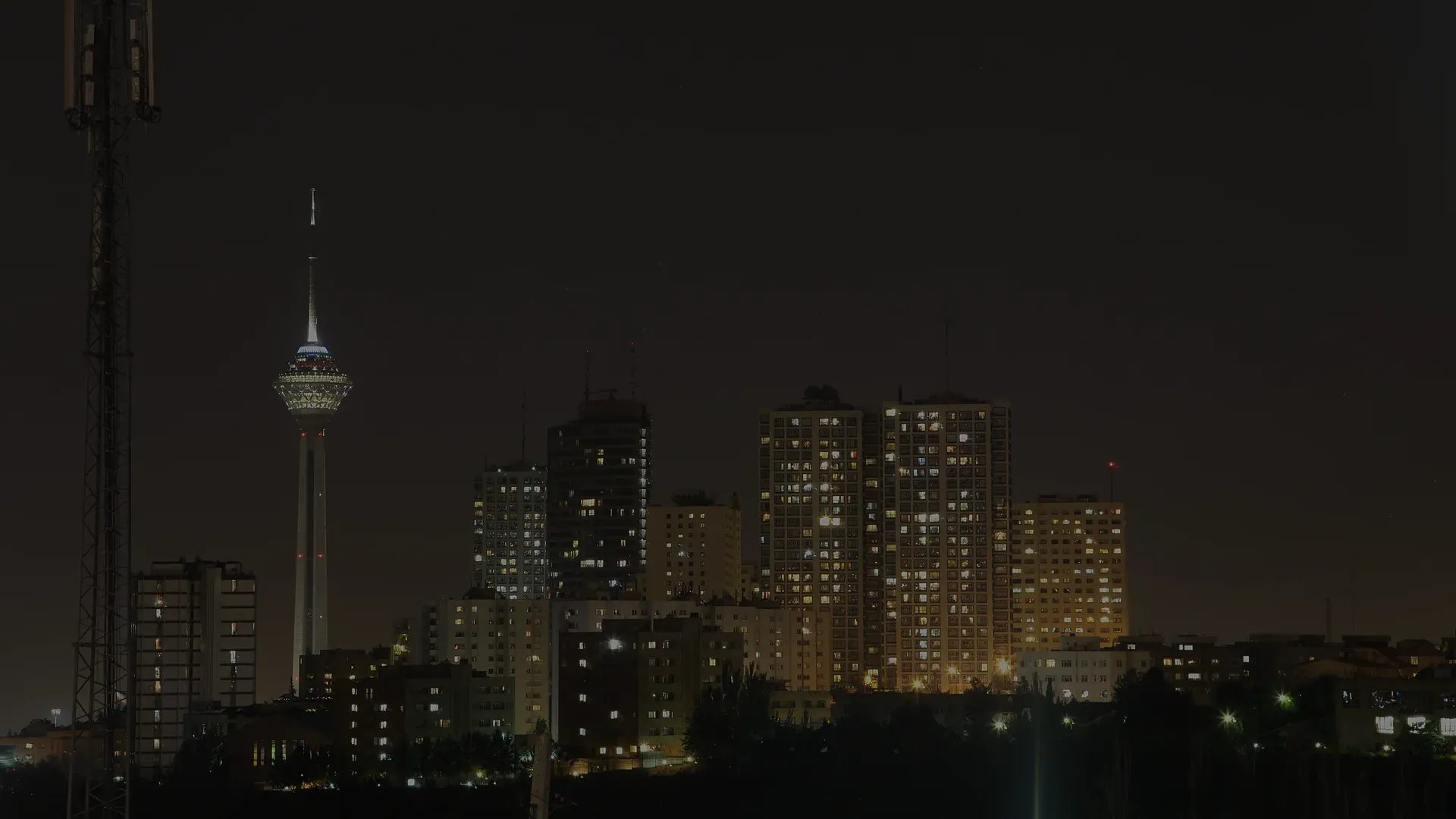 The Tehran skyline at dusk, illustrating the civilian impact of broad U.S. sanctions on Iran